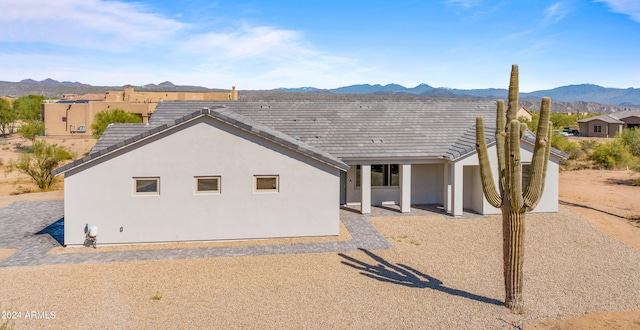 view of front facade with a patio, a mountain view, and a pergola