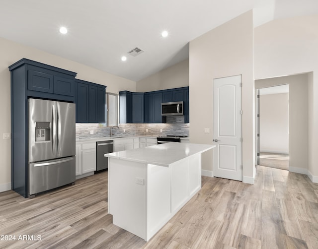 kitchen featuring light hardwood / wood-style floors, stainless steel appliances, backsplash, a center island, and high vaulted ceiling