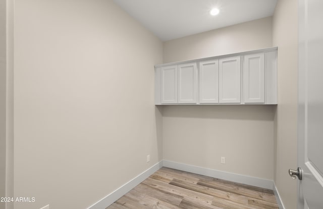 clothes washing area featuring light hardwood / wood-style flooring