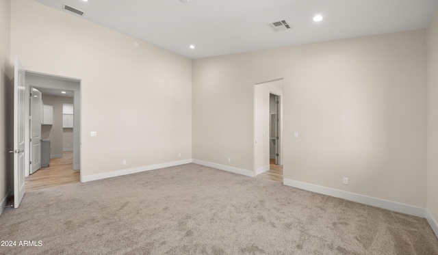 unfurnished room with light colored carpet