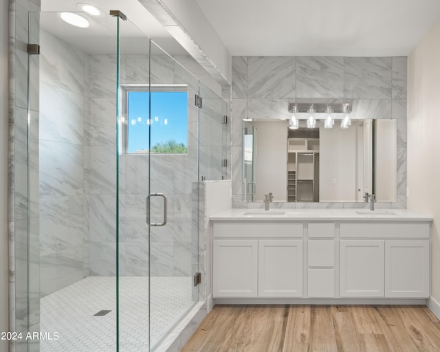 bathroom featuring vanity, a shower with shower door, and wood-type flooring