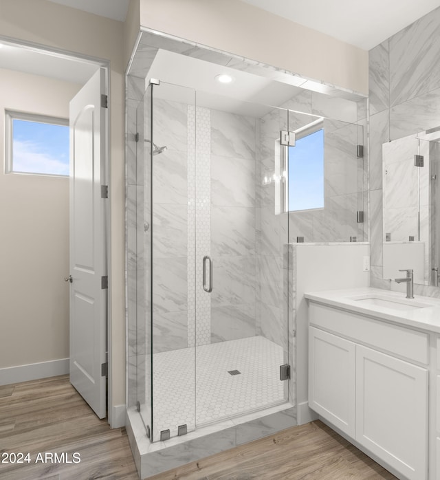 bathroom with vanity, wood-type flooring, and walk in shower