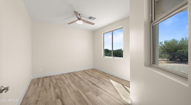 empty room with light hardwood / wood-style flooring and ceiling fan