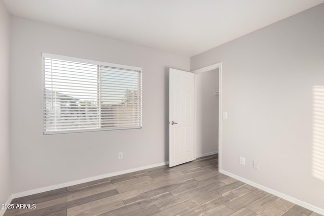 unfurnished room with light hardwood / wood-style floors