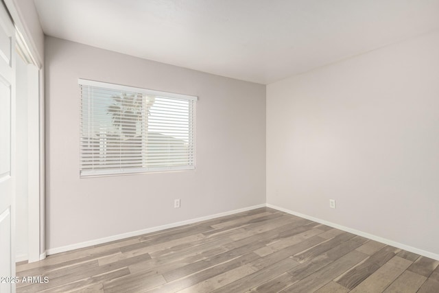 spare room with hardwood / wood-style floors