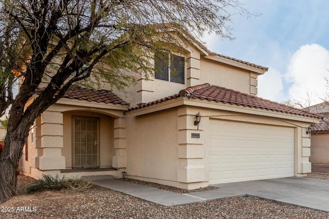 mediterranean / spanish-style home with a garage