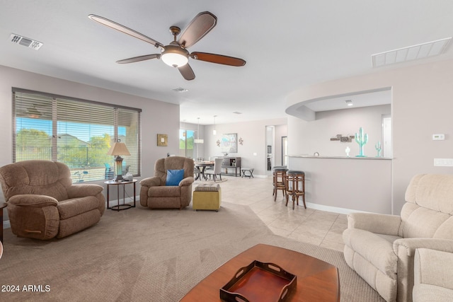 living room with ceiling fan and light tile patterned floors