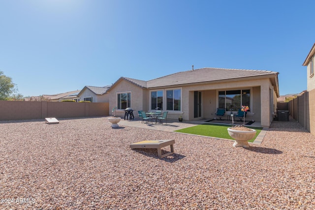 back of property with cooling unit and a patio area