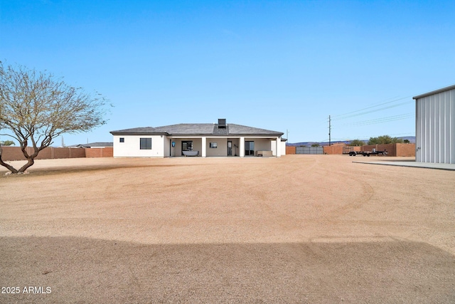 view of front of house featuring fence