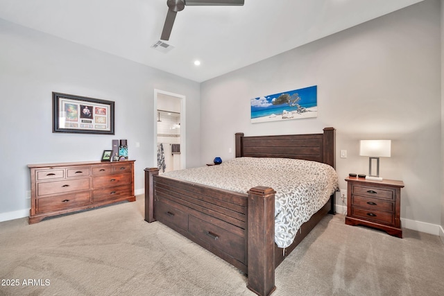 bedroom with a ceiling fan, light colored carpet, baseboards, and ensuite bathroom