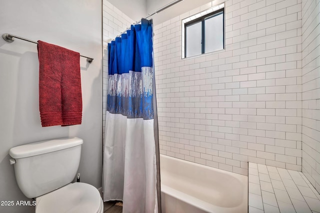 bathroom with shower / tub combo and toilet