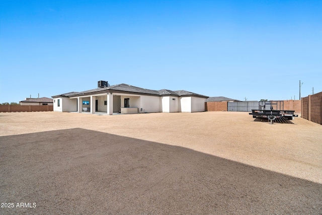 exterior space featuring cooling unit and a fenced backyard