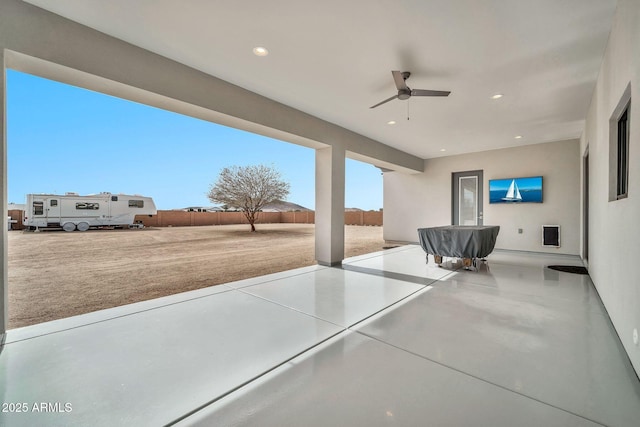 view of patio / terrace with ceiling fan and fence