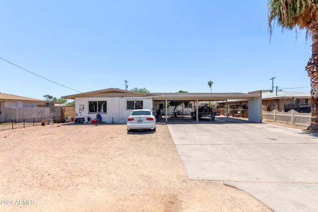 view of front of property featuring a carport