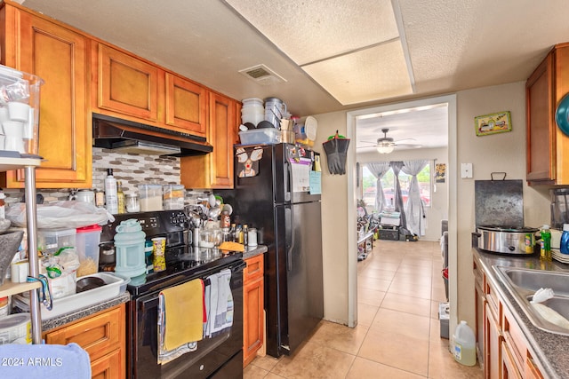 kitchen with ceiling fan, light tile flooring, black appliances, backsplash, and sink