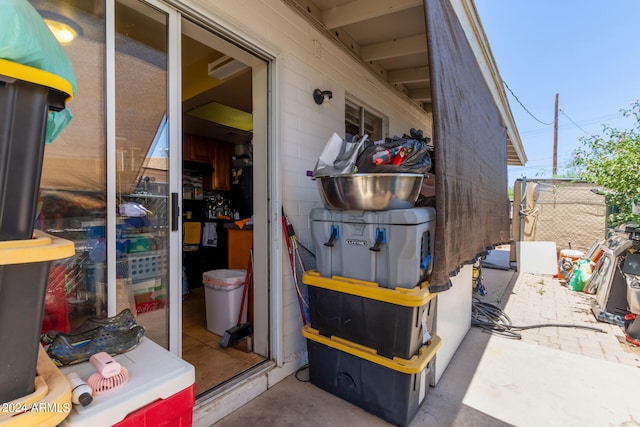 view of exterior entry with a patio