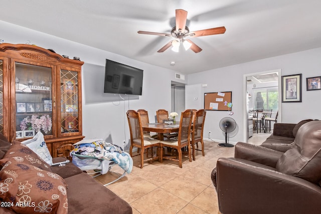 tiled living room with ceiling fan