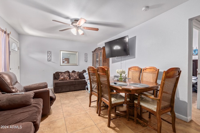 tiled dining area with ceiling fan