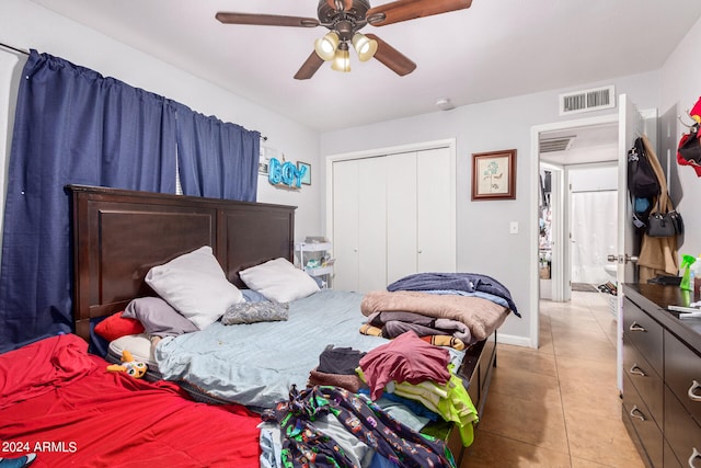 tiled bedroom with a closet and ceiling fan