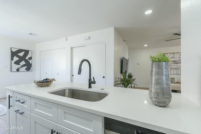 kitchen with white cabinetry and sink