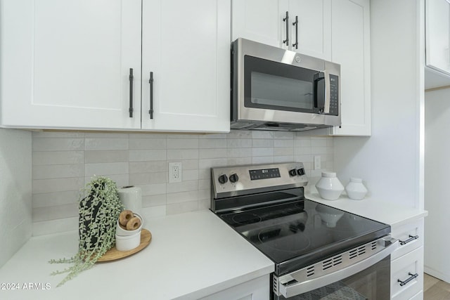 kitchen with appliances with stainless steel finishes and white cabinetry