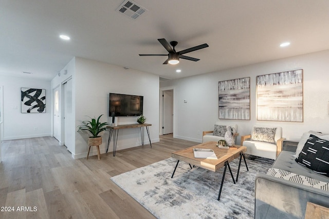 living room featuring ceiling fan and light wood-type flooring