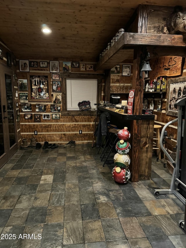 wine room featuring bar and wood ceiling