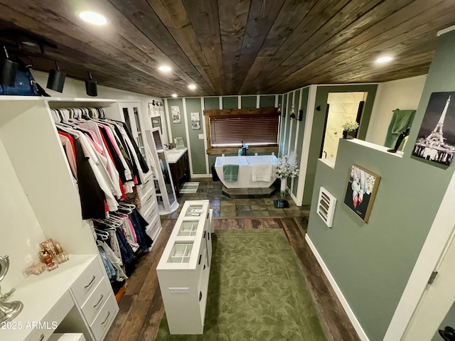 spacious closet with dark hardwood / wood-style flooring