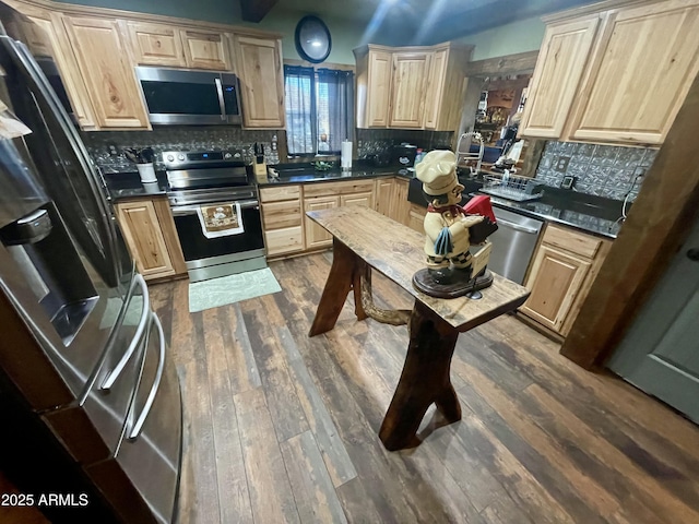 kitchen featuring light brown cabinetry, stainless steel appliances, and dark hardwood / wood-style floors