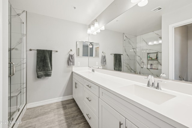 bathroom featuring an enclosed shower, vanity, and hardwood / wood-style flooring