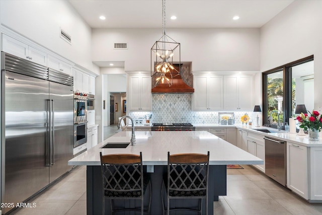 kitchen with a sink, visible vents, appliances with stainless steel finishes, and light countertops