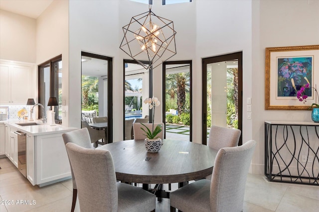 dining room featuring a high ceiling and a chandelier