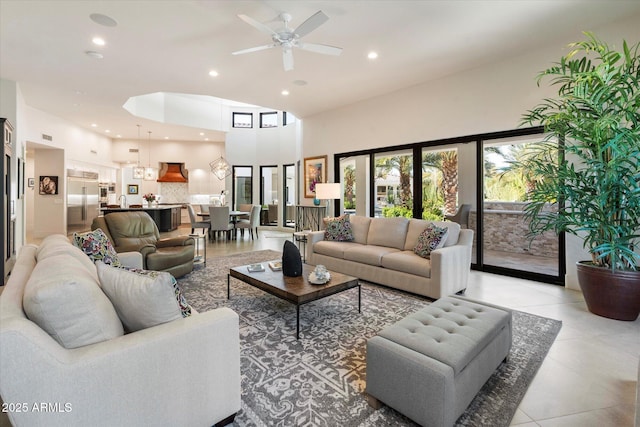 living room featuring visible vents, ceiling fan, light tile patterned floors, recessed lighting, and a high ceiling