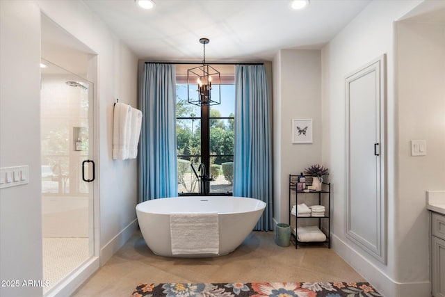 bathroom with recessed lighting, a soaking tub, a stall shower, and vanity