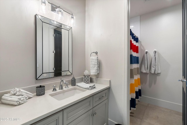 bathroom featuring tile patterned flooring, vanity, and baseboards