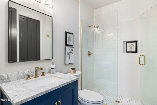 bathroom with vanity, toilet, and a stall shower