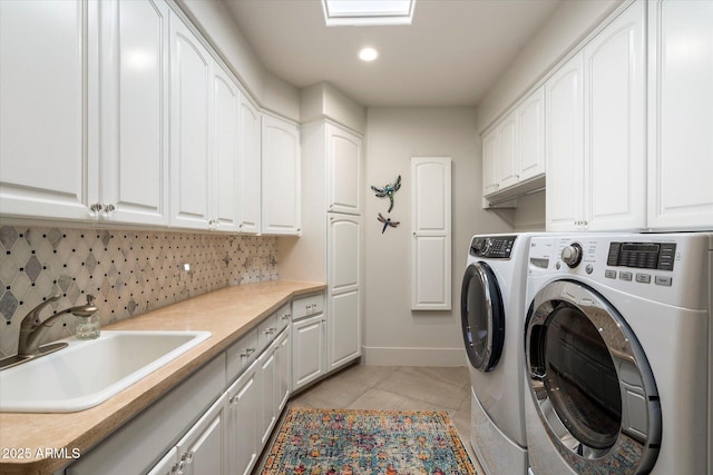 laundry room featuring a sink, recessed lighting, cabinet space, separate washer and dryer, and light tile patterned floors