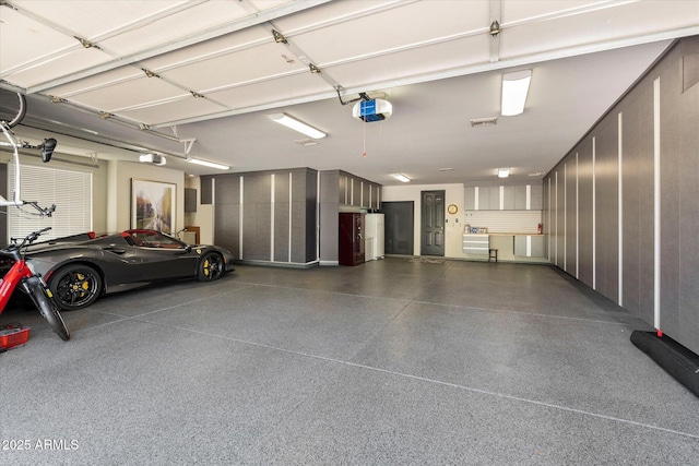 garage with refrigerator and a garage door opener