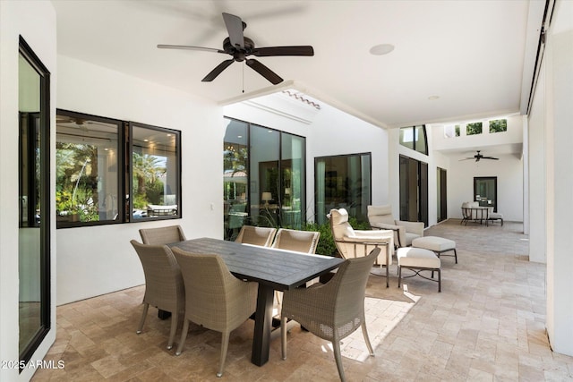 view of patio with outdoor dining area and ceiling fan