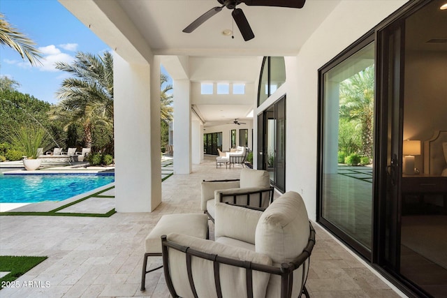 pool with a patio and a ceiling fan