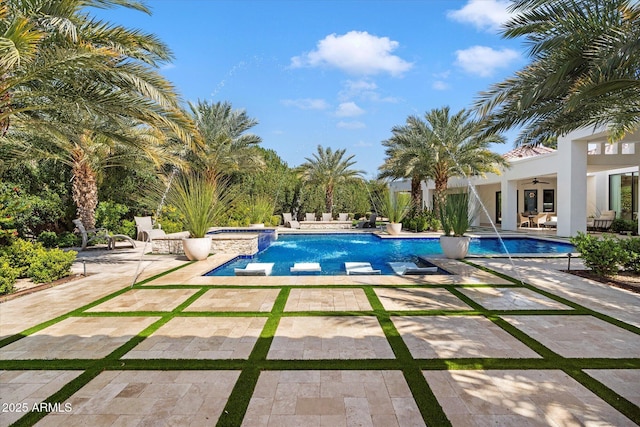 outdoor pool featuring an in ground hot tub, ceiling fan, and a patio area