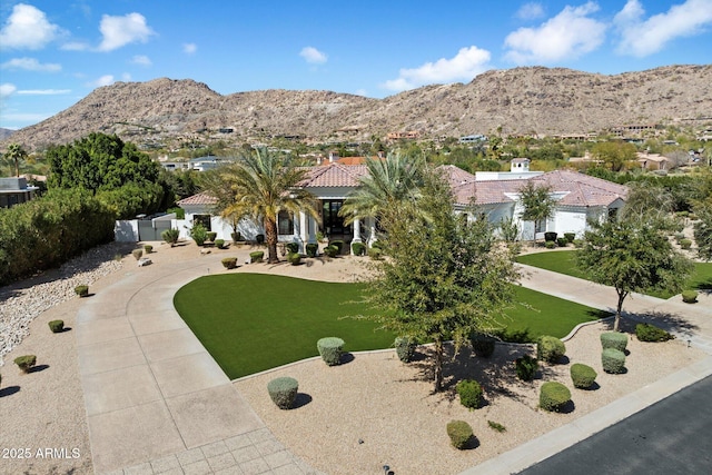 exterior space featuring a mountain view and a front lawn