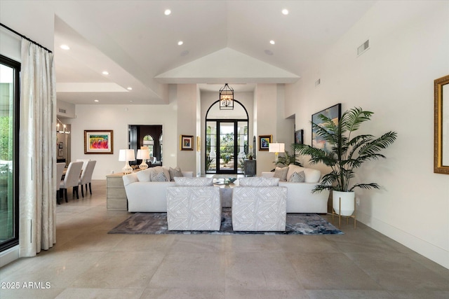 living room with visible vents, recessed lighting, high vaulted ceiling, and baseboards