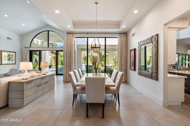 dining room featuring a high ceiling, a notable chandelier, baseboards, and visible vents