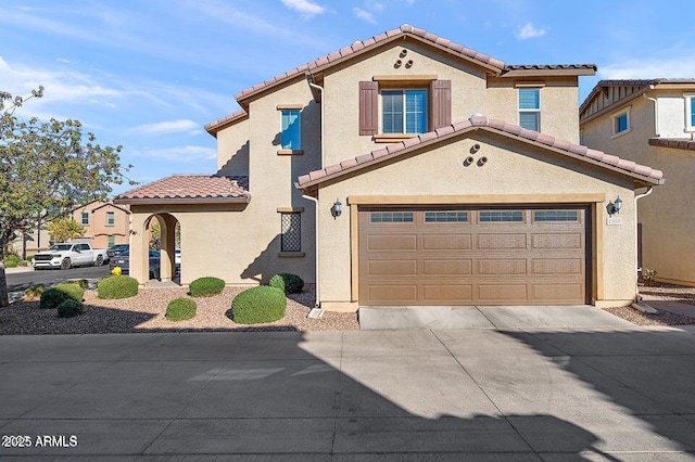 1255 N Banning, Mesa, AZ 85205 - mediterranean / spanish-style home with stucco siding, an attached garage, a tiled roof, and driveway