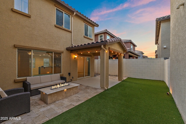 1255 N Banning, Mesa, AZ 85205 - back of property at dusk with stucco siding, a patio, and a tiled roof