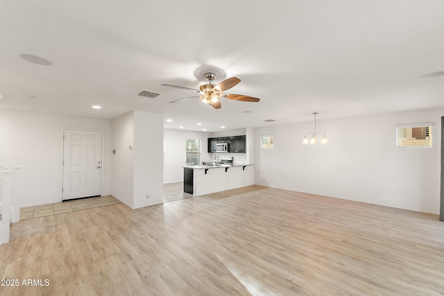 1255 N Banning, Mesa, AZ 85205 - unfurnished living room with recessed lighting, light wood-style flooring, visible vents, and ceiling fan with notable chandelier