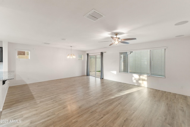 1255 N Banning, Mesa, AZ 85205 - unfurnished room featuring plenty of natural light, visible vents, light wood-style flooring, and ceiling fan with notable chandelier