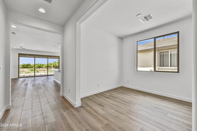 unfurnished room with light wood-type flooring