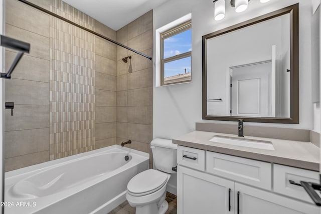 full bathroom with vanity, toilet, and tiled shower / bath